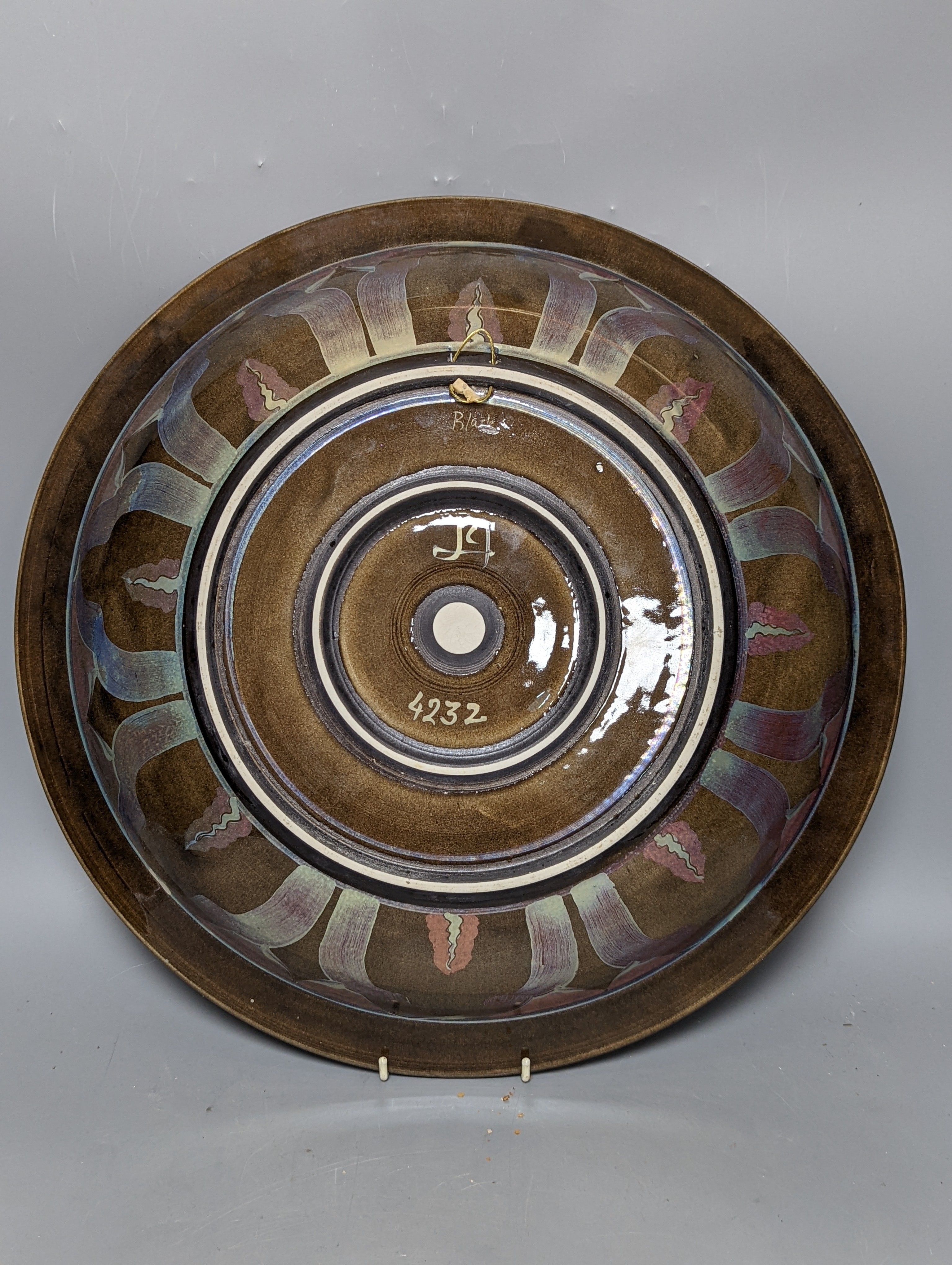 Jonathan Chiswell-Jones. A pomegranate pattern reduction fired lustre charger, numbered 4232, diameter 44cm